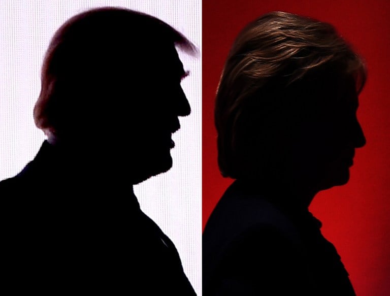 This combination of file photos shows the silhouettes of Republican presidential nominee Donald Trump (R) July 18, 2016 and Democratic presidential nominee Hillary Clinton on February 4, 2016. (AFP PHOTO / DESK)