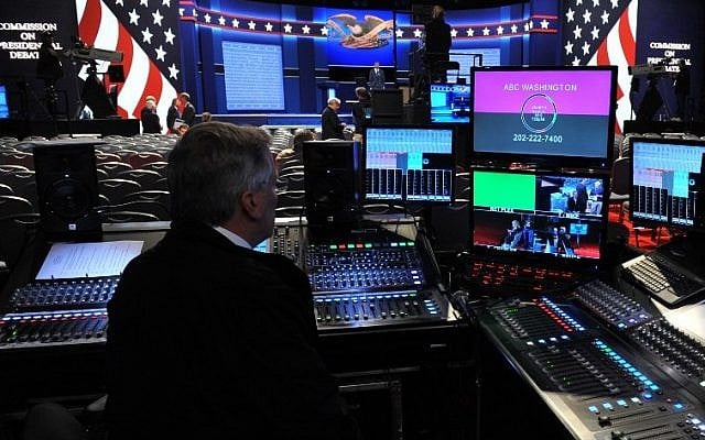A TV technician is seen by the stage of the first presidential debate at Hofstra University's David & Mack Sport and Exhibition Complex in Hempstead, New York on September 26, 2016. (AFP / Timothy A. CLARY)