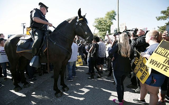 Mounted Detroit Police help control protesters as they protest Republican Presidential Nominee Donald Trump's visit to Great Faith International Ministries Church September 3, 2016 in Detroit, Michigan. (Bill Pugliano/Getty Images/AFP)