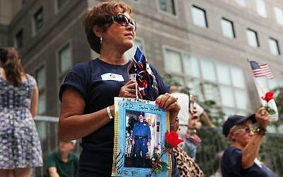 Family members of fallen officers watch a procession in Lower Manhattan to mark the 15th anniversary of the 9/11 attacks and the police officers who were killed during and after the event, on September 9, 2016 in New York City. (Spencer Platt/Getty Images/AFP)