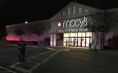 Law enforcement officers stand in front of the Macy's department store at the Cascade Mall in Burlington, Wash., where the Washington State Patrol reports a fatal shooting, Friday, Sept. 23, 2016. (Rick Lund/The Seattle Times via AP)