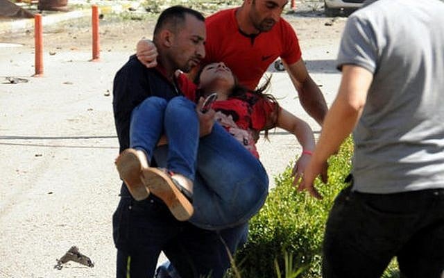 People carry a wounded person after a car bomb attack in the city center of Van, eastern Turkey, Monday, Sept. 12, 2016. (DHA via AP) People carry a wounded person after a car bomb attack in the city center of Van, eastern Turkey, Monday, Sept. 12, 2016. (DHA via AP)