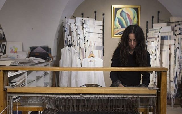 Adi Yair weaving on the loom of a prayer shawl shop in the Cardo of Jerusalem's Jewish Quarter in 2015 (Courtesy Adi Yair) Adi Yair weaving on the loom of a prayer shawl shop in the Cardo of Jerusalem's Jewish Quarter in 2015 (Courtesy Adi Yair)