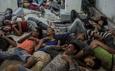 Young Egyptians detained at a police station sleep on the floor in Rosetta, Egypt, after rescued from a boat capsized off the Mediterranean coast near the Egyptian city of Alexandria, Wednesday, Sept. 21, 2016. (AP Photo/Eman Helal)