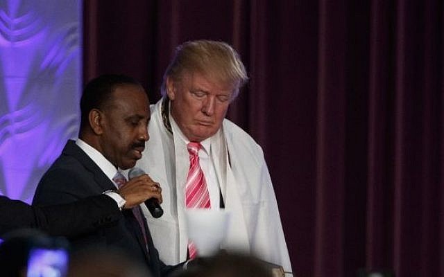 Donald Trump wears a tallit, or Jewish prayer shawl, as he's presented with a gift during a church service at Great Faith Ministries, Saturday, Sept. 3, 2016, in Detroit (Evan Vucci/AP) Donald Trump wears a tallit, or Jewish prayer shawl, as he's presented with a gift during a church service at Great Faith Ministries, Saturday, Sept. 3, 2016, in Detroit (Evan Vucci/AP)