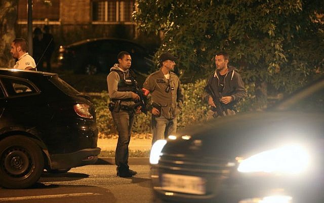 Police officers stand guard as they take part in a raid on suspected terror plotters in Boussy-Saint-Antoine, east of Paris, Thursday, Sept. 8, 2016. (AP Photo/Thibault Camus)