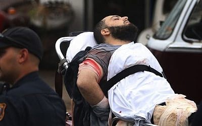 Ahmad Khan Rahami is taken into custody after a shootout with police Monday, Sept. 19, 2016, in Linden, New Jersey. (Ed Murray/NJ Advance Media via AP)