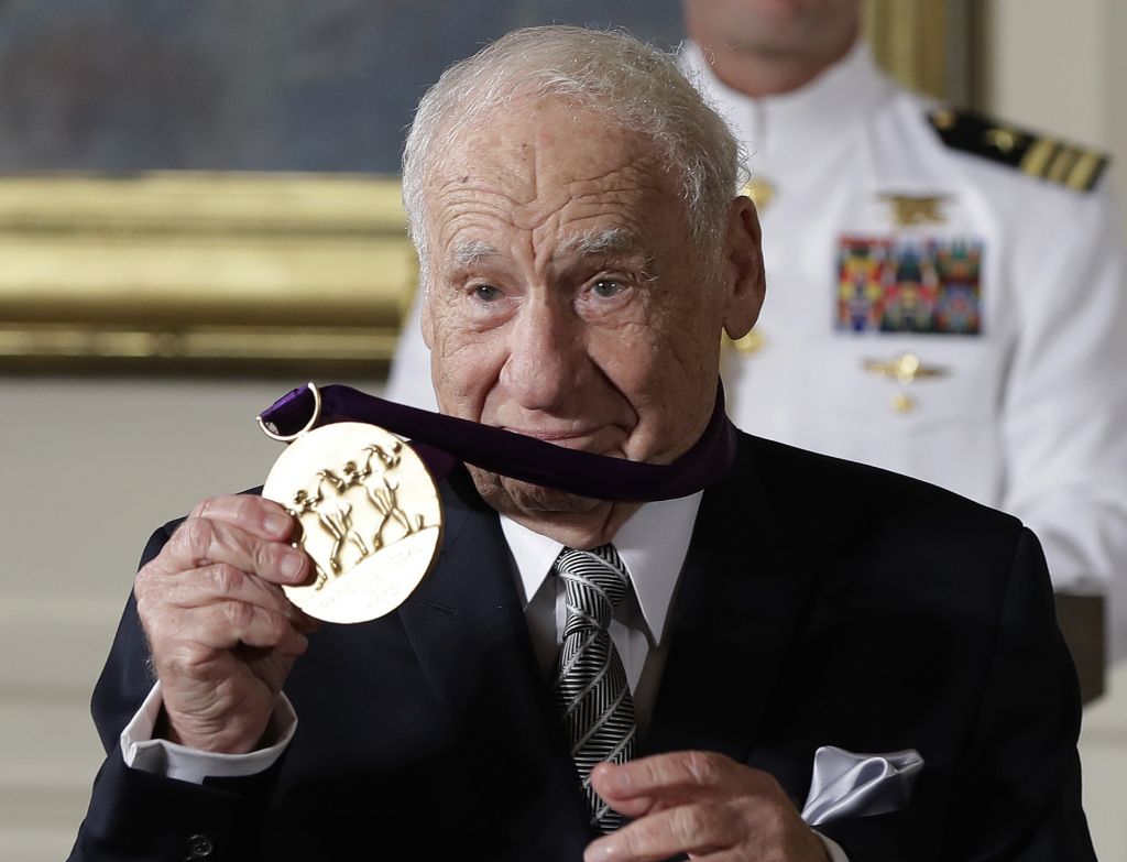 Actor, comedian and writer, Mel Brooks, holds up his 2015 National Medal of Arts awarded to him by President Barack Obama during a ceremony in the East Room of the White House, Thursday, Sept. 22, 2016, in Washington. (AP Photo/Carolyn Kaster)