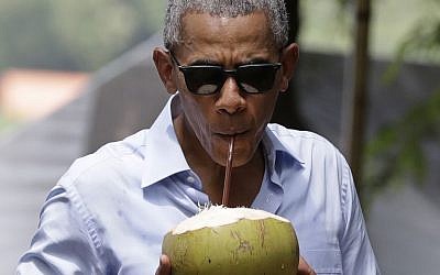 US President Barack Obama drinks from a fresh coconut along the banks of the Mekong River in the Luang Prabang, Laos, Wednesday, Sept. 7, 2016. (AP Photo/Carolyn Kaster) 