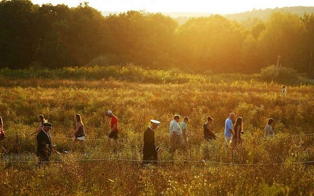 Visitors make their way through the Flight 93 National Memorial before lit candles are carried to the Wall of Names in memory of the passengers and crew of Flight 93, at the Flight 93 National Memorial in Shanksville, Pennsylvania, Saturday, Sept. 10, 2016, as the nation marks the 15th anniversary of the Sept. 11 attacks. (AP Photo/Jared Wickerham) Visitors make their way through the Flight 93 National Memorial before lit candles are carried to the Wall of Names in memory of the passengers and crew of Flight 93, at the Flight 93 National Memorial in Shanksville, Pennsylvania, Saturday, Sept. 10, 2016, as the nation marks the 15th anniversary of the Sept. 11 attacks. (AP Photo/Jared Wickerham)