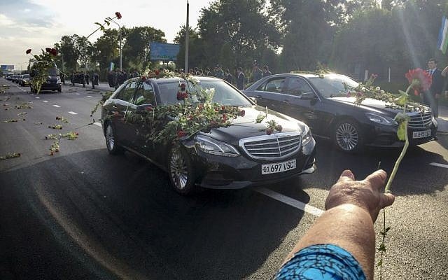 People throw flowers on limousines as they gather along a road to watch the funeral procession of President Islam Karimov in Tashkent, Uzbekistan, September 3, 2016. (AP/Umida Akhmedova) People throw flowers on limousines as they gather along a road to watch the funeral procession of President Islam Karimov in Tashkent, Uzbekistan, September 3, 2016. (AP/Umida Akhmedova)