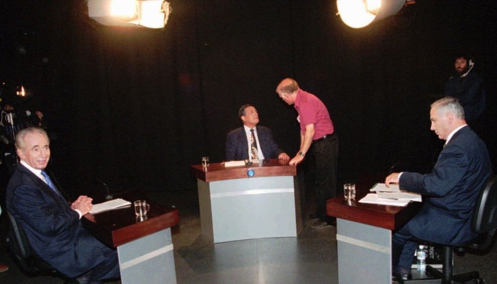 Prime minister and head of the Labor party Shimon Peres, left, and Benjamin Netanyahu, head of the opposition Likud party, right, sit in a Tel Aviv studio between mediator Dan Margalit, center, as they wait for the beginning of their televised debate, Sunday May 26 1996. (AP PHOTO/Yisrael Hadari/pool) Prime minister and head of the Labor party Shimon Peres, left, and Benjamin Netanyahu, head of the opposition Likud party, right, sit in a Tel Aviv studio between mediator Dan Margalit, center, as they wait for the beginning of their televised debate, Sunday May 26 1996. (AP PHOTO/Yisrael Hadari/pool)