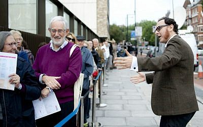 Raymond Simonson, chief executive of the JW3 community center in London, greets visitors at the JCC’s opening in 2013. (Blake Ezra Photography via JTA)