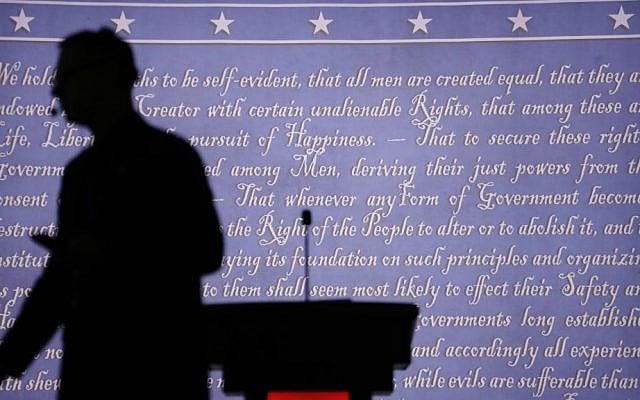 A producer walks past a podium on the stage for the presidential debate between Democratic presidential candidate Hillary Clinton and Republican presidential candidate Donald Trump at Hofstra University in Hempstead, New York, Monday, Sept. 26, 2016. (AP Photo/David Goldman)