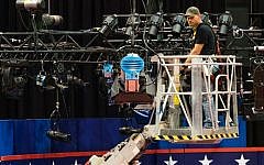 A technician examines the lighting grid as preparations continue for Monday's first presidential debate between Democrat Hillary Clinton and Republican Donald Trump, Saturday, Sept. 24, 2016, at Hofstra University in Hempstead, New York. (AP Photo/J. David Ake)