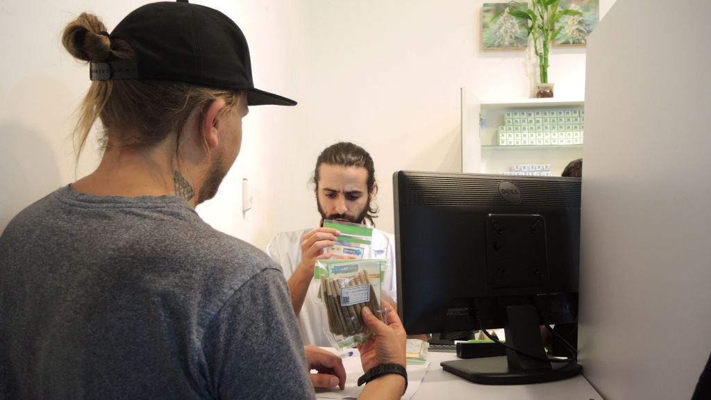 A Tikun Olam pharmacist metes out a patient's monthly medical marijuana prescription at the Tel Aviv dispensary on September 1, 2016. (Melanie Lidman/Times of Israel)