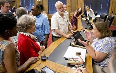 In this Aug. 9, 2016 file photo, Chairwoman Kathryn Lindley, right, is approached by people during the Guilford County Board of Elections meeting at the Old Guilford County Courthouse in Greensboro, N.C. (Joseph Rodriguez/News & Record via AP)