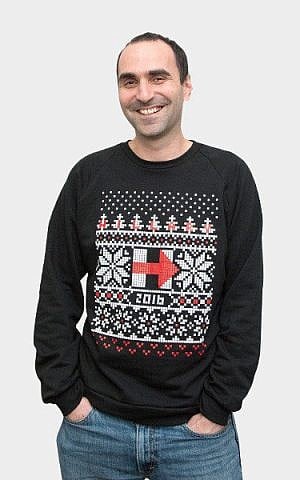 Elan Kriegel, Hillary Clinton’s chief number’s cruncher, hawks a Christmas sweater for her campaign. (Clinton campaign.)