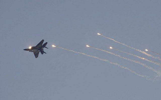 An F-15I tactical fighter jet releases flares during a graduation ceremony of new Israeli Air Force pilots at the Hatzerim Air Force base near the southern city of Beersheba, December 27, 2012. (Flash90)