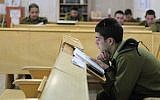 Soldiers study religious texts in the IDF's ultra-Orthodox 'Netzah Yehuda' unit at the Peles Military Base in the northern Jordan valley, August 2013. (Yaakov Naumi/Flash90)