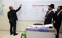 Naftali Bennett, left, at an ultra-Orthodox school in Tel Aviv on May 10, 2016. (Yaacov Cohen/Flash90)