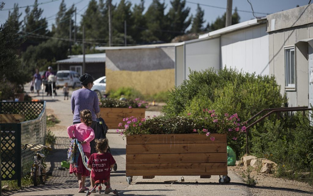 Families walk on a street in the Amona Jewish outpost in the West Bank, on July 28, 2016. (Hadas Parush/Flash90) Families walk on a street in the Amona Jewish outpost in the West Bank, on July 28, 2016. (Hadas Parush/Flash90)