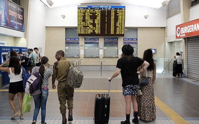Travelers at central Tel Aviv's central Savidor station checking a schedule, where no trains northbound are listed, on September 3, 2016. (Tomer Neuberg/Flash90) Travelers at central Tel Aviv's central Savidor station checking a schedule, where no trains northbound are listed, on September 3, 2016. (Tomer Neuberg/Flash90)