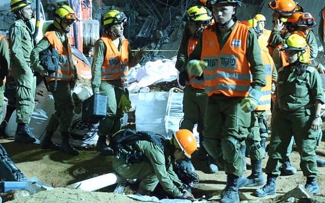 Rescue workers at the site of a four-storey parking garage collapse on September 5, 2016 in the Ramat Hahayal neighborhood of Tel Aviv. FLASH90) Rescue workers at the site of a four-storey parking garage collapse on September 5, 2016 in the Ramat Hahayal neighborhood of Tel Aviv. FLASH90)