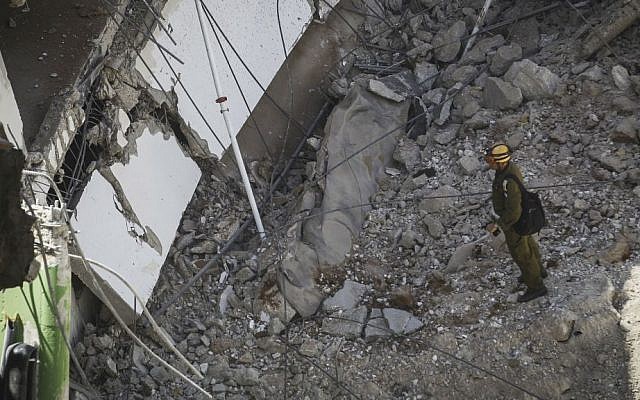 A rescue worker at the site of a collapsed parking structure in the Ramat Hahayal neighborhood in northern Tel Aviv, September 5, 2016. (Miriam Alster/Flash90) A rescue worker at the site of a collapsed parking structure in the Ramat Hahayal neighborhood in northern Tel Aviv, September 5, 2016. (Miriam Alster/Flash90)