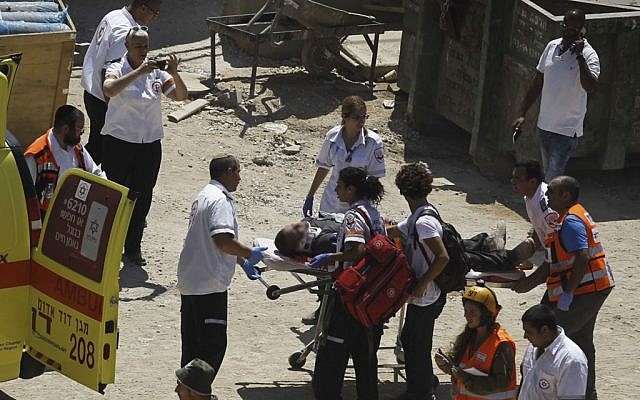 Rescue workers evacuate a wounded man at the site where a building collapsed in Tel Aviv on September 5, 2016. (Miriam Alster/Flash90) Rescue workers evacuate a wounded man at the site where a building collapsed in Tel Aviv on September 5, 2016. (Miriam Alster/Flash90)