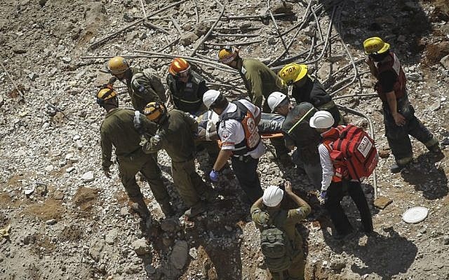 Rescue workers evacuate a wounded man from a collapsed parking structure in the Ramat Hahayal neighborhood in northern Tel Aviv, September 5, 2016. (Miriam Alster/Flash90) Rescue workers evacuate a wounded man from a collapsed parking structure in the Ramat Hahayal neighborhood in northern Tel Aviv, September 5, 2016. (Miriam Alster/Flash90)