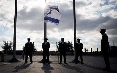 The Knesset honor guard lowers the Israeli flag to half-staff during a ceremony in memory of Shimon Peres on September 28, 2016 (Hadas Parushl/Flash90)