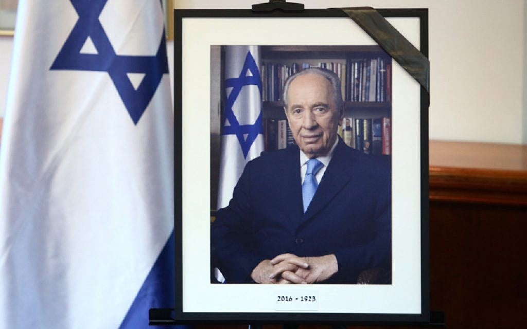 A photograph of former President Shimon Peres framed with his year of birth and year of passing, 1923-2016, is presented at the Prime Minister's Office in Jerusalem, on September 28, 2016. (Marc Israel Sellem/POOL)