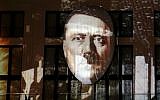 The face of Adolf Hitler is projected onto a 3D canvas as part of an art installation during a rehearsal for the "Berlin Leuchtet" ("Berlin shines") festival in Berlin, Germany, Thursday, Sept. 29, 2016. (AP Photo/Michael Sohn)