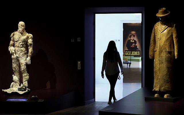 A woman walks past a Golem costume of the Malenki Theater in Tel Aviv, left, and a Golem sculpture of the Schaubuehne Theatre in Berlin for 'Death, Destruction and Detroit II', right, during a press presentation for the 'Golem' exhibition at the Jewish Museum in Berlin, Germany, Thursday, Sept. 22, 2016. (AP Photo/Michael Sohn) A woman walks past a Golem costume of the Malenki Theater in Tel Aviv, left, and a Golem sculpture of the Schaubuehne Theatre in Berlin for 'Death, Destruction and Detroit II', right, during a press presentation for the 'Golem' exhibition at the Jewish Museum in Berlin, Germany, Thursday, Sept. 22, 2016. (AP Photo/Michael Sohn)