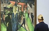 A woman stands in front of the painting 'Potsdamer Platz' from 1914 by artist Ernst Ludwig Kirchner displayed at the 'Hamburger Bahnhof - Museum for Contemporary Arts' in Berlin, Tuesday, Sept. 20, 2016. (AP Photo/Markus Schreiber)