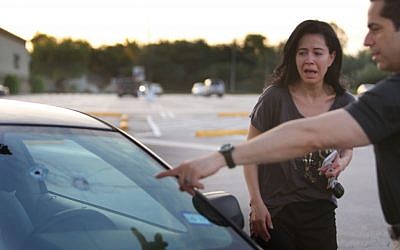 Alan Wakim shows his wife, Jennifer Molleda, where two bullets entered his windshield and went past his face during a shooting along Wesleyan at Law Street in Houston that left multiple people injured and the alleged shooter dead, Sunday morning, September 25, 2016, in Houston. (Mark Mulligan/Houston Chronicle via AP)