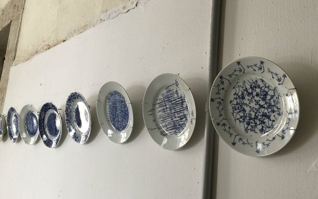 Artist Yaara Rabinowitz made a series of porcelain plates in a German factory featuring its original stamp  (Jessica Steinberg/Times of Israel)