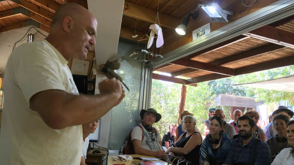 Birder Amir Balaban handles a bulbul in front of a group of Sacred Festival participants at the Jerusalem Bird Observatory on Wednesday, September 14, 2016 (Jessica Steinberg/Times of Israel) Birder Amir Balaban handles a bulbul in front of a group of Sacred Festival participants at the Jerusalem Bird Observatory on Wednesday, September 14, 2016 (Jessica Steinberg/Times of Israel)