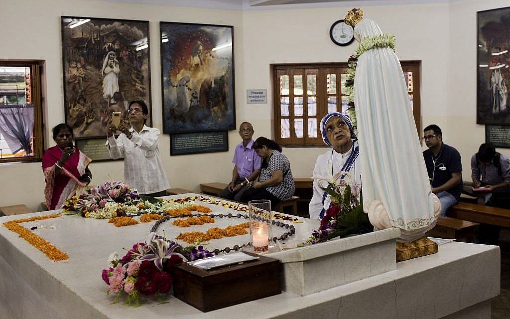 Worshippers gather around the tomb of Mother Teresa inside the Mother house in Kolkata, India, in Kolkata, India, on September 3, 2016. (Bernat Armangue/AP Photo)