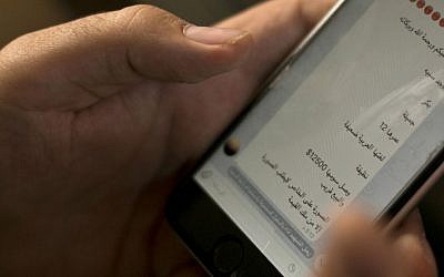 In this May 22, 2016 file photo, an activist looks at an Islamic State group marketplace on the encrypted app Telegram, advertising a 12-year-old Yazidi girl as a slave for the price of $12,500, in a photo taken in northern Iraq. "Peace be upon you and the mercy and blessings of God," the text reads in Arabic. "There is a female slave - Virgin - Beautiful - 12 years old - Her Arabic is weak - Clean - Her price has reached $12,500, and she will be sold soon. The photo is private. Only those who have the money may request the picture." (AP Photo/Maya Alleruzzo, File) Illustrative. An activist looks at an Islamic State group marketplace on the encrypted app Telegram. (AP Photo/Maya Alleruzzo)