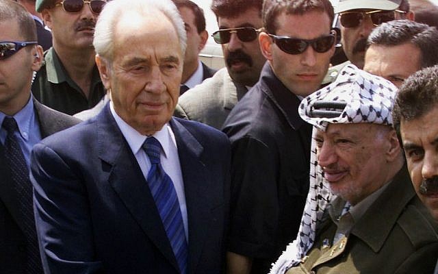 Palestinian leader Yasser Arafat (right), shakes hands with Israeli then-foreign minister Shimon Peres (left) after their meeting at Gaza International Airport, southern Gaza Strip, September 26, 2001. (AP/Laurent Rebours, File) Palestinian leader Yasser Arafat (right), shakes hands with Israeli then-foreign minister Shimon Peres (left) after their meeting at Gaza International Airport, southern Gaza Strip, September 26, 2001. (AP/Laurent Rebours, File)