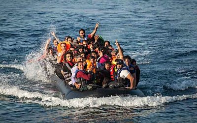 Illustrative: A dinghy carrying refugees arrives at a beach on the island of Lesbos in northern Greece. (Boaz Arad/IsraAid via JTA)