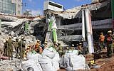 Soldiers in the IDF Home Front Command take part in the rescue effort at a collapsed parking garage in Tel Aviv's Ramat Hahayal neighborhood on September 6, 2016. (Judah Ari Gross/Times of Israel)