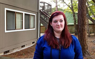 Amber Cathey, next-door neighbor and former high school classmate of Cascade Mall shooting suspect Arcan Cetin, stands in front of their building in this Oak Harbor, Washington, complex, September 25, 2016. (AP Photo/Martha Bellisle)