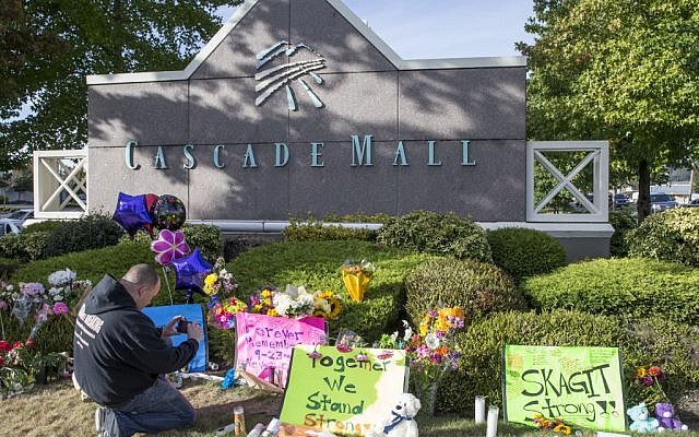 Chris Nelson of Burlington, Washington, takes a picture of a memorial on September 25, 2016, in Burlington, to five victims killed in a shooting on Friday at a Cascade Mall. (AP Photo/Stephen Brashear) Chris Nelson of Burlington, Washington, takes a picture of a memorial on September 25, 2016, in Burlington, to five victims killed in a shooting on Friday at a Cascade Mall. (AP Photo/Stephen Brashear)