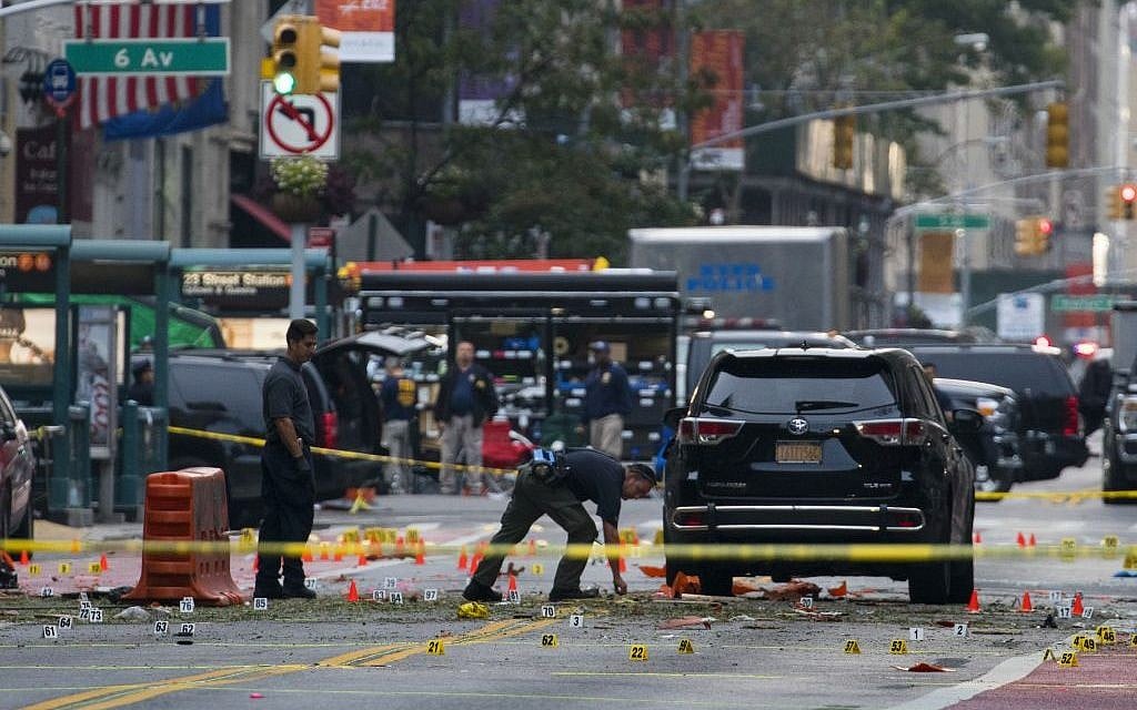 Crime scene investigators work at the scene of Saturday's explosion in Manhattan's Chelsea neighborhood, in New York, Sunday, Sept. 18, 2016. (AP Photo/Craig Ruttle)