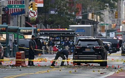 Crime scene investigators work at the scene of Saturday's explosion in Manhattan's Chelsea neighborhood, in New York, Sunday, Sept. 18, 2016. (AP Photo/Craig Ruttle)