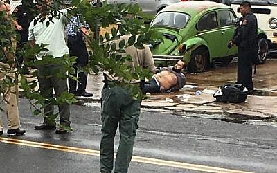 Ahmad Khan Rahami is taken into custody after a shootout with police Monday, in Linden, NJ, September 19, 2016. (Moshe Weiss via AP)