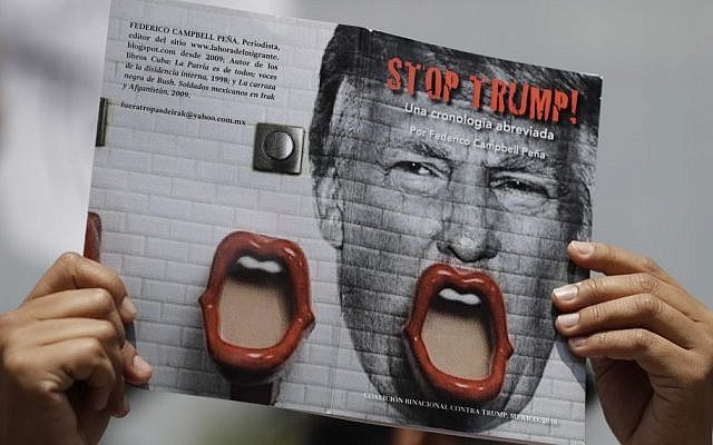 Illustrative: A demonstrator protesting Donald Trump's meeting with the Mexican president holds up a book jacket with the title "Stop Trump!" during a morning protest at the Angel of Independence Monument that drew just a handful of people, in Mexico City, August 31, 2016. (AP/Rebecca Blackwell) Illustrative: A demonstrator protesting Donald Trump's meeting with the Mexican president holds up a book jacket with the title "Stop Trump!" during a morning protest at the Angel of Independence Monument that drew just a handful of people, in Mexico City, August 31, 2016. (AP/Rebecca Blackwell)